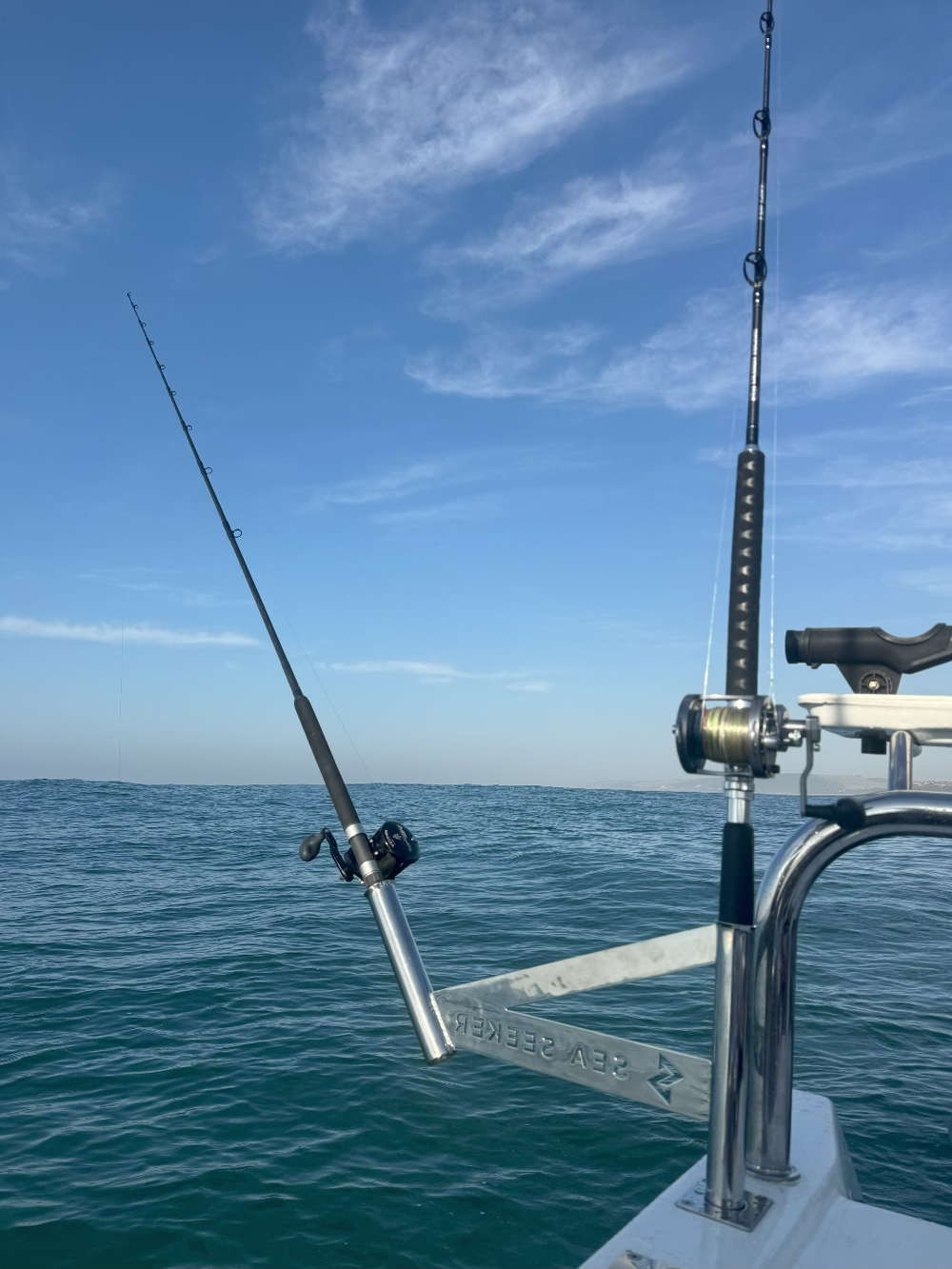 sea seeker holding two fishing poles